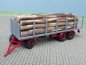 Preview: 1/87 Brekina 3achs Rungenanhänger grau mit Baumstämmen